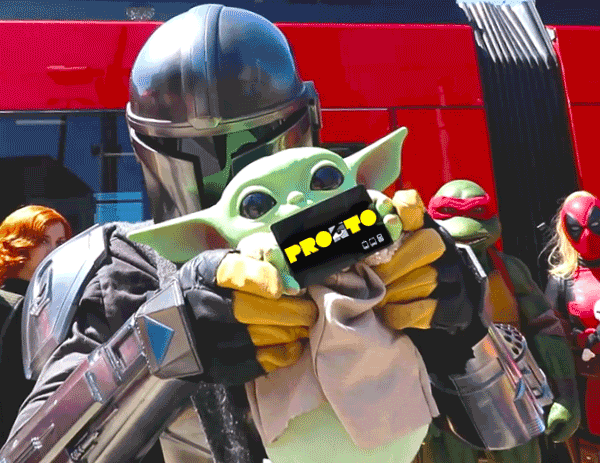 A person in costume is holding a Comic-Con branded PRONTO card
