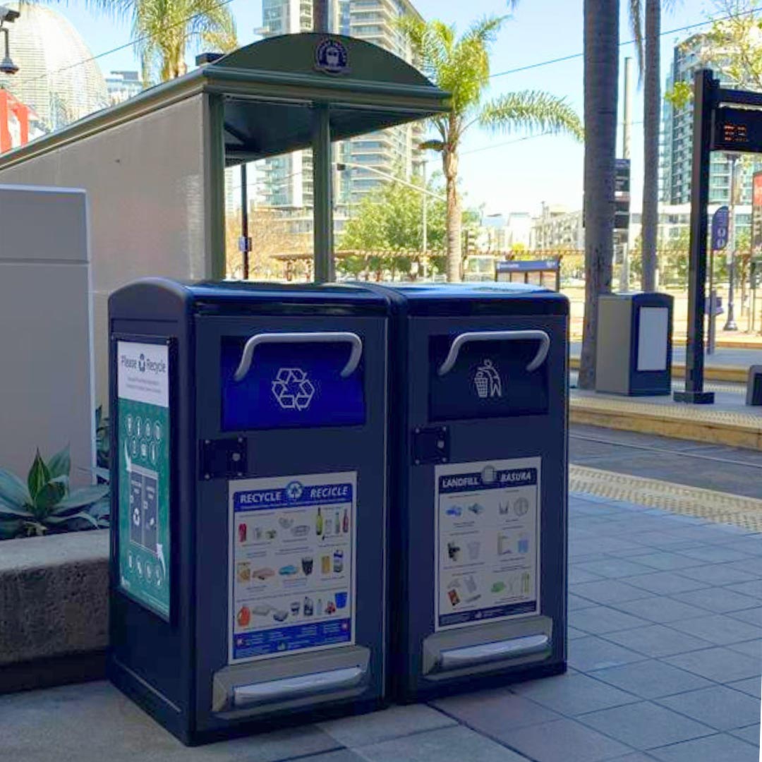 Side by side large enclosed trash and recycling bins