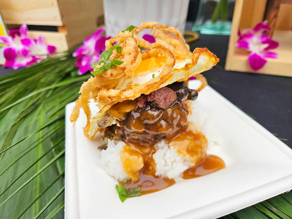 Plate with rice, gravy, hamburger patty, mushrooms, egg, and onion strings.