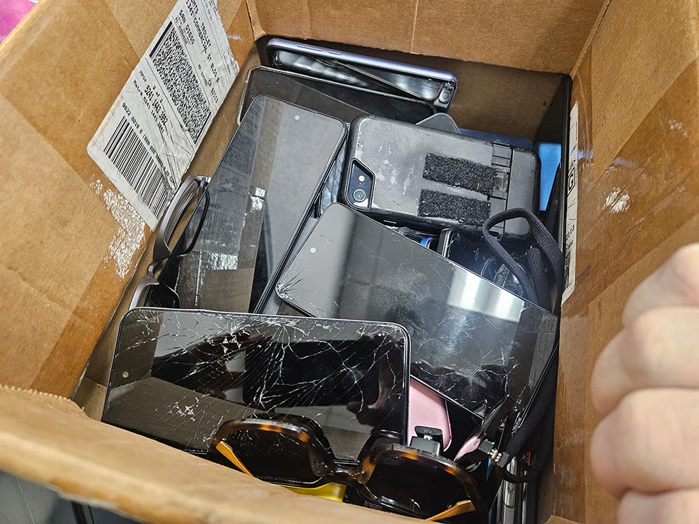 Box filled with lost phones and sunglasses
