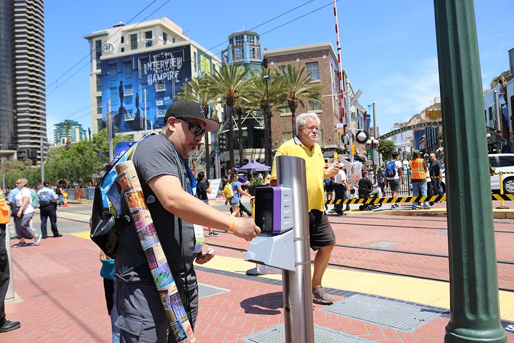 A rider taps their card before riding the Trolley during Comic-Con.