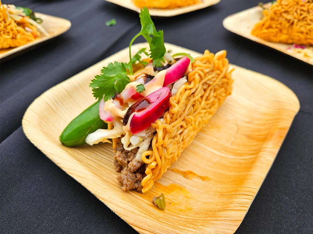 Bamboo plate with ramen taco shell with meat and toppings