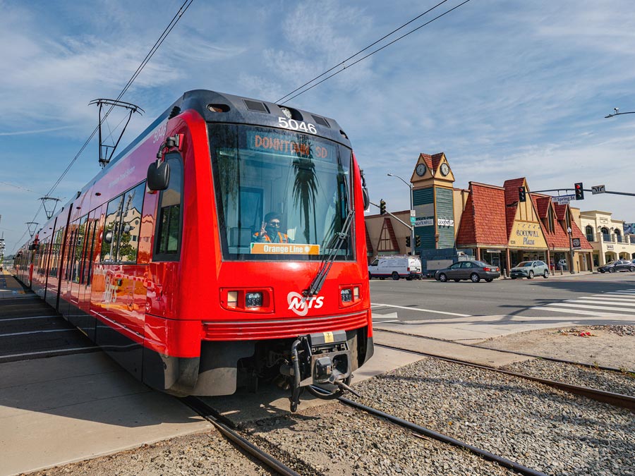 San Diego Trolley on the tracks in La Mesa with buildings in the background