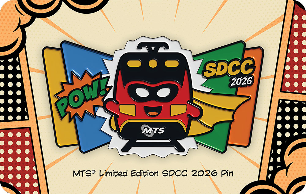A pin of the Trolley wearing a mask and a cape, with a POW! sign on the left and SDCC 2026 on the right on a four panel yellow, blue, green and orange background