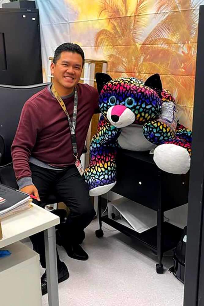 Robinaire Ruiz, Assistant Transit Store Supervisor, with a plushie that was turned into Lost and Found.