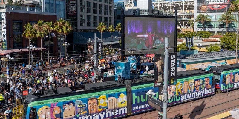 Hulu Wrapped Trolley at Gaslamp Quarter station during Comic-Con with a crowd in the background