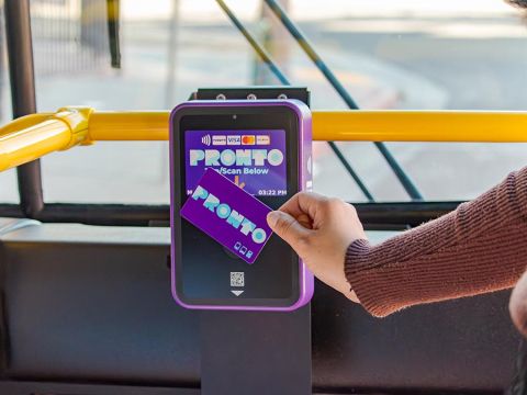 PRONTO Card being tapped by hand on a validator on board a bus.