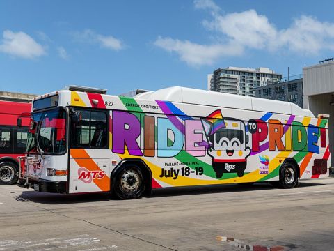 MTS Bus wrapped with a rainbow, the Bus mascot, and says Ride to Pride
