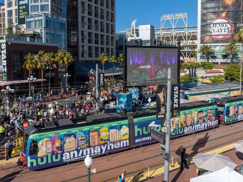 Hulu Wrapped Trolley at Gaslamp Quarter station during Comic-Con with a crowd in the background