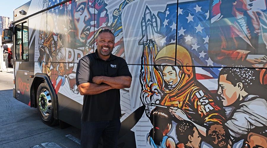 Artist Ibn Edwards with Black History Month MTS Bus