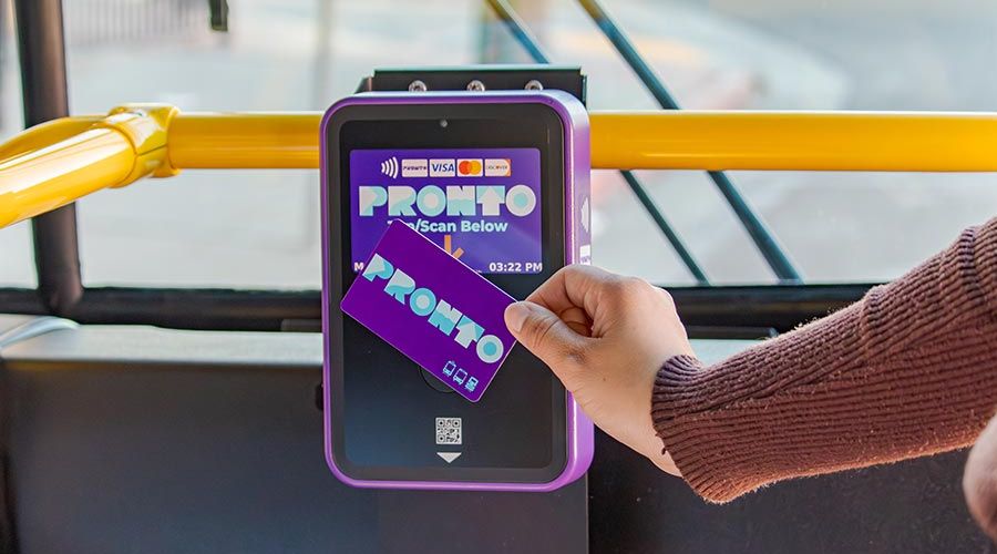 PRONTO Card being tapped by hand on a validator on board a bus.