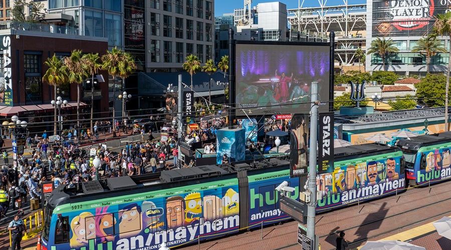 Hulu Wrapped Trolley at Gaslamp Quarter station during Comic-Con with a crowd in the background