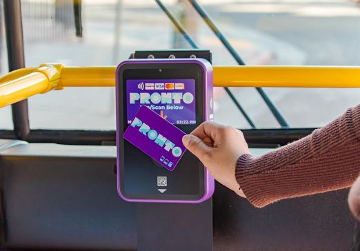 PRONTO Card being tapped by hand on a validator on board a bus.