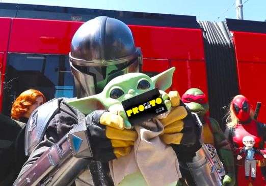 Grogu and the Mandalorian with the SDCC PRONTO card in front of the Trolley