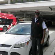 Lewis stands next to a road supervisor car